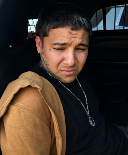 Raymond Garcia sits inside a law enforcement vehicle after being arrested by New Mexico State Police on a California murder warrant.