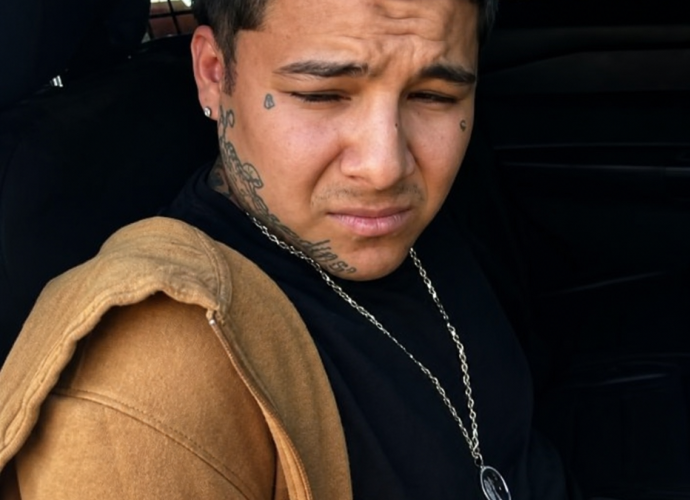 Raymond Garcia sits inside a law enforcement vehicle after being arrested by New Mexico State Police on a California murder warrant.