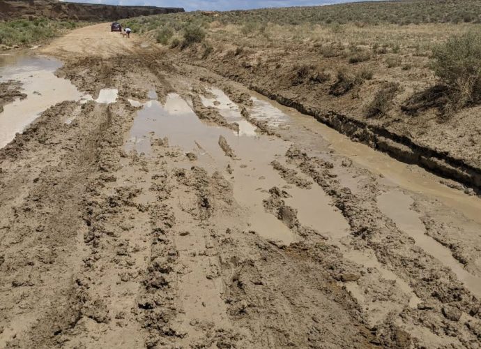 Deep tire ruts in a muddy dirt road on BLM-managed public land in Southern New Mexico.