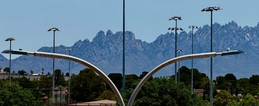 Street lights in Las Cruces with the Organ Mountains in the background.