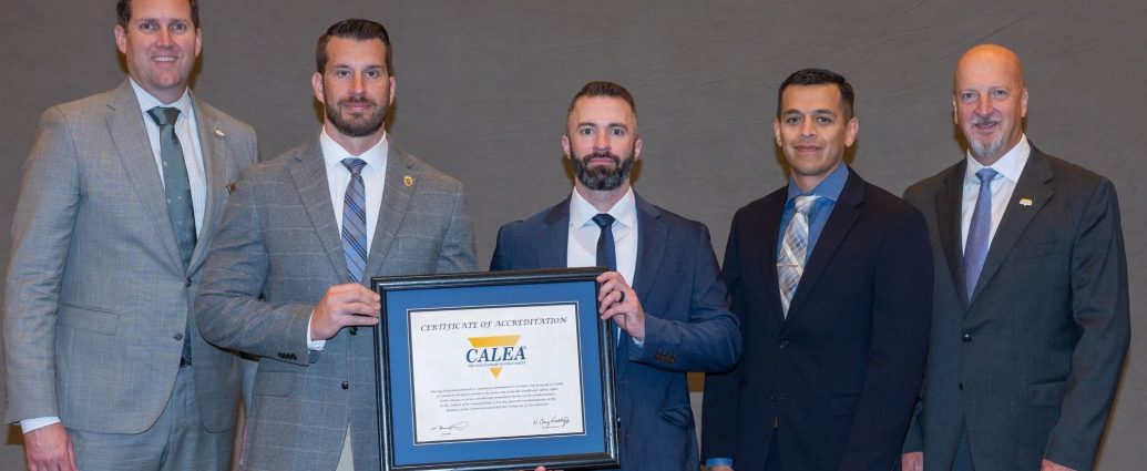 Las Cruces Police Department representatives hold CALEA accreditation certificate.