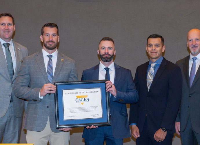 Las Cruces Police Department representatives hold CALEA accreditation certificate.