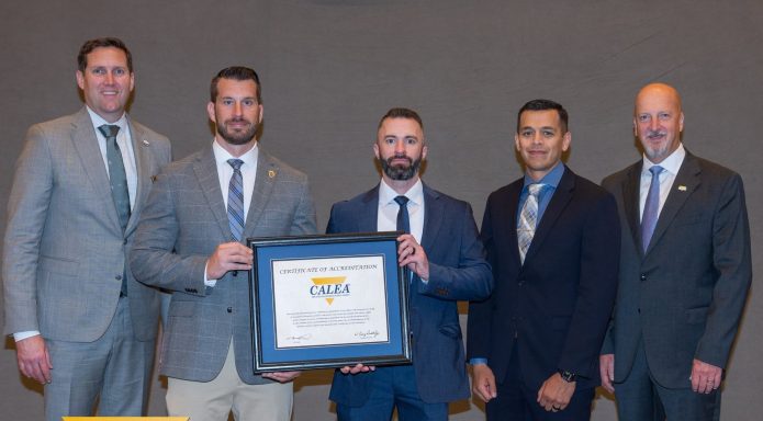 Las Cruces Police Department representatives hold CALEA accreditation certificate.