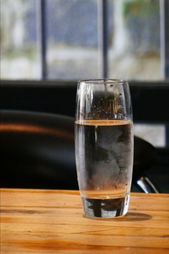 Glass of drinking water representing a Las Cruces Utilities warning about a scam involving unauthorized water quality flyers. Photo courtesy: Bravo Mic Communications, LLC.