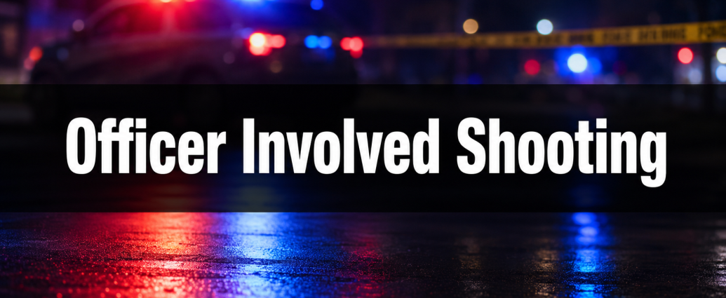 Blurred red and blue law-enforcement lights with yellow scene tape and the words “Officer Involved Shooting.”