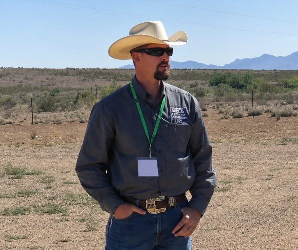 Russell Johnson, president of the Luna County Farm and Livestock Bureau, stands in the New Mexico desert during a public meeting discussing concerns over federal groundwater wells associated with border wall construction.
