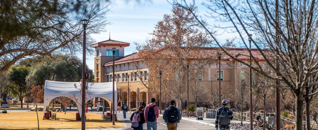 Students walk across the New Mexico State University campus in Las Cruces.