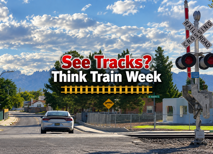 Railroad crossing in Las Cruces with See Tracks? Think Train Week safety message.