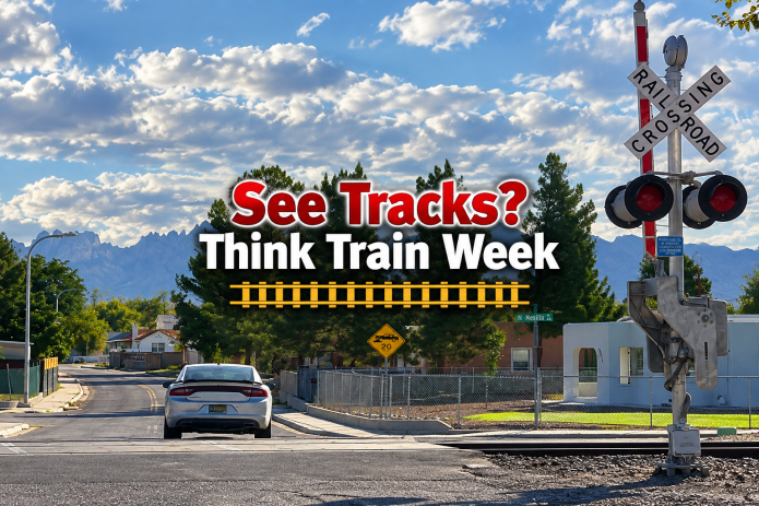 Railroad crossing in Las Cruces with See Tracks? Think Train Week safety message.