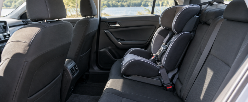 Empty child safety seat secured in the rear seat of a car