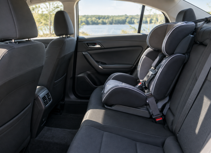 Empty child safety seat secured in the rear seat of a car