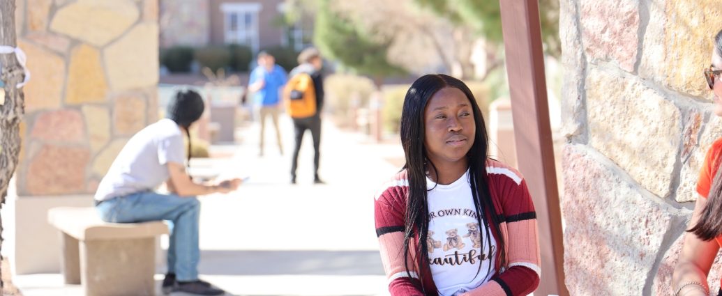 DACC student sitting outdoors on the Doña Ana Community College campus