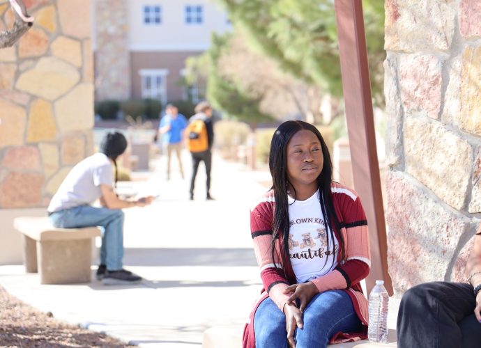 DACC student sitting outdoors on the Doña Ana Community College campus
