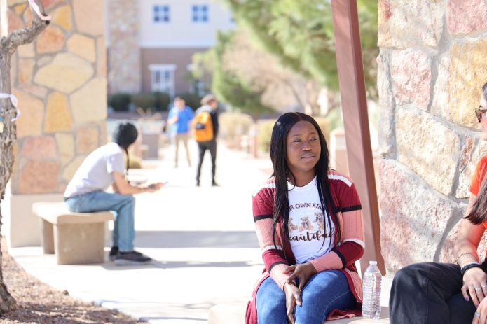 DACC student sitting outdoors on the Doña Ana Community College campus