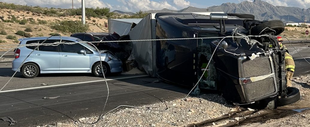 An overturned semi-truck and a car at a crash scene near Anthony.